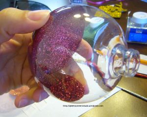 Completely coat the inside of the ornament with glitter